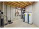 Unfinished basement featuring water heaters, a breaker box, and exposed ductwork at 9263 Compton Farm Ln, Indianapolis, IN 46259