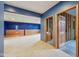 Partially finished basement featuring blue walls and wood paneling with an unfinished bathroom at 9263 Compton Farm Ln, Indianapolis, IN 46259