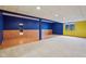 Finished basement featuring blue and yellow walls, carpet, and wood-look flooring at 9263 Compton Farm Ln, Indianapolis, IN 46259