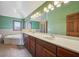 A double sink bathroom is brightly lit with a jetted soaking tub at 9263 Compton Farm Ln, Indianapolis, IN 46259
