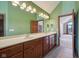 Bright bathroom featuring a double vanity with a long mirror and earth-tone tile floors at 9263 Compton Farm Ln, Indianapolis, IN 46259