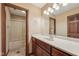 Bathroom vanity with wooden cabinets, a large mirror, modern fixtures, and a tiled floor at 9263 Compton Farm Ln, Indianapolis, IN 46259