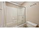 Bathroom features a shower-tub combo with sliding glass door and updated fixtures at 9263 Compton Farm Ln, Indianapolis, IN 46259