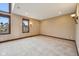 Comfortable bedroom with carpeting, warm lighting, and scenic windows at 9263 Compton Farm Ln, Indianapolis, IN 46259