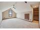 Spacious bedroom with an attic ceiling, large window, a ceiling fan, and built in shelving at 9263 Compton Farm Ln, Indianapolis, IN 46259