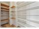 Walk-in closet with a combination of white and natural wood shelving for optimal storage solutions at 9263 Compton Farm Ln, Indianapolis, IN 46259
