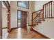 Inviting entryway featuring hardwood floors and a classic staircase at 9263 Compton Farm Ln, Indianapolis, IN 46259