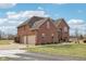 Corner exterior showcasing the brick house with a two car garage and mature landscaping at 9263 Compton Farm Ln, Indianapolis, IN 46259
