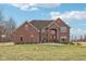 Beautiful front exterior of brick two-story home with manicured lawn and a basketball hoop at 9263 Compton Farm Ln, Indianapolis, IN 46259