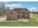 Majestic brick home with a large front yard, an arched entry, and a basketball hoop at 9263 Compton Farm Ln, Indianapolis, IN 46259