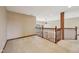 Upstairs hallway with plush carpet, neutral walls, and a wooden railing overlooking the home's interior at 9263 Compton Farm Ln, Indianapolis, IN 46259