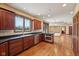 Well-lit kitchen features stainless steel appliances, wooden cabinets, and hardwood floors at 9263 Compton Farm Ln, Indianapolis, IN 46259