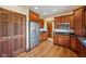 This kitchen has stainless steel refrigerator, dark cabinets, and hardwood flooring at 9263 Compton Farm Ln, Indianapolis, IN 46259