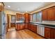 Bright kitchen features dark wood cabinetry, stainless steel appliances, and hardwood floors at 9263 Compton Farm Ln, Indianapolis, IN 46259