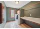 Well-lit laundry room with a countertop, a large window, built-in cabinets, and a washer and dryer at 9263 Compton Farm Ln, Indianapolis, IN 46259