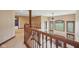 Open-concept living area features tall windows, a staircase with wood banisters, and a fireplace below at 9263 Compton Farm Ln, Indianapolis, IN 46259