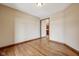 Room with hardwood flooring, light-colored walls, and wood trim leading to another room showcasing kitchen cabinets at 9263 Compton Farm Ln, Indianapolis, IN 46259