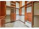 Walk-in closet with custom wood shelves, drawers, and clothes racks at 9263 Compton Farm Ln, Indianapolis, IN 46259