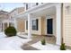 Front porch of a yellow house with a dark blue front door and white columns at 9476 Lantern Ln, Pendleton, IN 46064