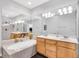 Spa-like bathroom with double vanities, a large soaking tub, and shower at 141 S Meridian St # 605, Indianapolis, IN 46225