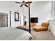 Primary bedroom with a large TV, ceiling fan and ensuite bathroom at 141 S Meridian St # 605, Indianapolis, IN 46225