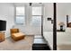 Bedroom with city views, featuring a chaise lounge and a post bed at 141 S Meridian St # 605, Indianapolis, IN 46225