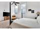 Bright bedroom with city view, large windows, and a comfortable seating area at 141 S Meridian St # 605, Indianapolis, IN 46225