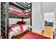 Cozy bedroom featuring a bunk bed and red accents at 141 S Meridian St # 605, Indianapolis, IN 46225