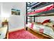 Bedroom with a bunk bed and red bedding, hardwood floors and a small rug at 141 S Meridian St # 605, Indianapolis, IN 46225