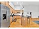Modern kitchen with light wood cabinets and a large island with seating at 141 S Meridian St # 605, Indianapolis, IN 46225