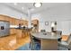 Open concept kitchen with light wood cabinets, island, and dining area at 141 S Meridian St # 605, Indianapolis, IN 46225