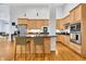 Modern kitchen with light wood cabinets, a large island with seating at 141 S Meridian St # 605, Indianapolis, IN 46225