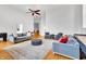 Spacious living room with hardwood floors, comfy seating, and a large ceiling fan at 141 S Meridian St # 605, Indianapolis, IN 46225