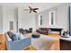 Open living area with hardwood floors, comfy seating, and two large windows at 141 S Meridian St # 605, Indianapolis, IN 46225