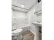 Bathroom featuring a white shower-tub, pedestal sink, and commode at 1819 Southeastern Ave, Indianapolis, IN 46201