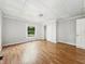 A simple bedroom with light gray walls, hardwood floors, and closet at 1819 Southeastern Ave, Indianapolis, IN 46201