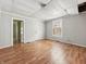 Bedroom highlighting its wood floors, plain walls, and multiple doors leading to different areas at 1819 Southeastern Ave, Indianapolis, IN 46201