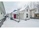 White house with red door and snowy front yard at 1819 Southeastern Ave, Indianapolis, IN 46201