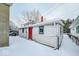 Detached garage with red door, winter scene at 1819 Southeastern Ave, Indianapolis, IN 46201