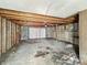 Unfinished garage interior with a white garage door and overhead lighting at 1819 Southeastern Ave, Indianapolis, IN 46201