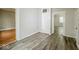 Hallway with wood-look vinyl flooring and access to other rooms at 1819 Southeastern Ave, Indianapolis, IN 46201