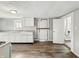 Functional kitchen with white cabinets, countertops, and newer-looking vinyl flooring at 1819 Southeastern Ave, Indianapolis, IN 46201