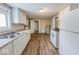 Bright kitchen features white cabinets, stainless steel sink, and wood-look flooring at 1819 Southeastern Ave, Indianapolis, IN 46201