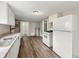 This functional kitchen features vinyl floors and essential appliances at 1819 Southeastern Ave, Indianapolis, IN 46201