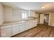 White kitchen cabinets and vinyl flooring in galley-style kitchen at 1819 Southeastern Ave, Indianapolis, IN 46201