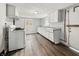 Functional kitchen with vinyl floors, white cabinets, and essential appliances at 1819 Southeastern Ave, Indianapolis, IN 46201