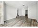 Living room with light gray walls and dark floors with multiple doorways at 1819 Southeastern Ave, Indianapolis, IN 46201
