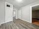 Living room with light gray walls and dark floors with multiple doorways at 1819 Southeastern Ave, Indianapolis, IN 46201