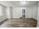 Living room with wood-look floors and access to other rooms at 1819 Southeastern Ave, Indianapolis, IN 46201