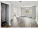 Living room with light gray walls and dark floors with multiple doorways at 1819 Southeastern Ave, Indianapolis, IN 46201